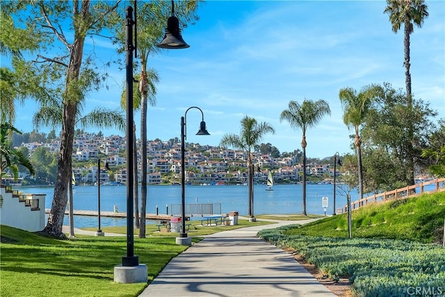 view of home's community featuring a yard and a water view
