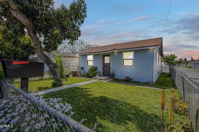 2461 Balboa St, Oxnard, CA 93036 - view of front of house featuring a fenced backyard, a lawn, and roof with shingles