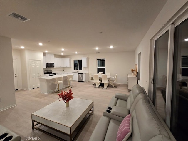 19427 Seeding Palace Cir, Riverside, CA 92507 - living area featuring recessed lighting, baseboards, and light wood-style floors