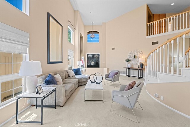 45422 Camino Monzon, Temecula, CA 92592 - living area with a high ceiling, stairs, baseboards, and carpet floors
