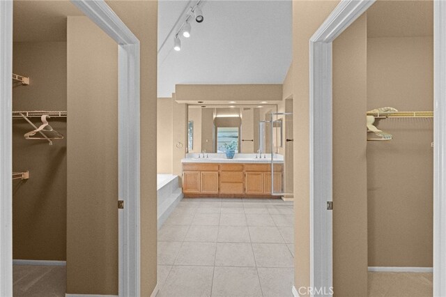 45422 Camino Monzon, Temecula, CA 92592 - bathroom with double vanity, a bath, a spacious closet, and tile patterned floors
