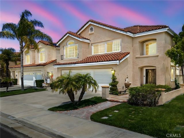 45422 Camino Monzon, Temecula, CA 92592 - mediterranean / spanish-style home featuring an attached garage, a tile roof, stucco siding, and driveway