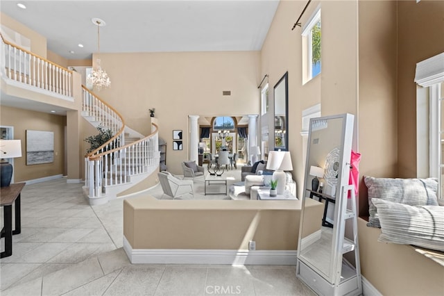 45422 Camino Monzon, Temecula, CA 92592 - tiled living area featuring a towering ceiling, a chandelier, stairs, baseboards, and recessed lighting