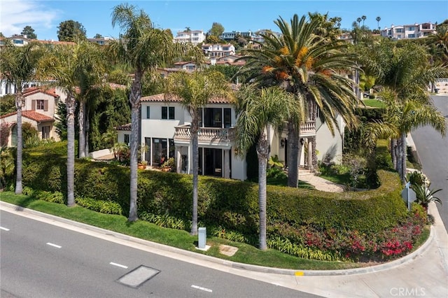 view of front of home featuring a balcony and stucco siding