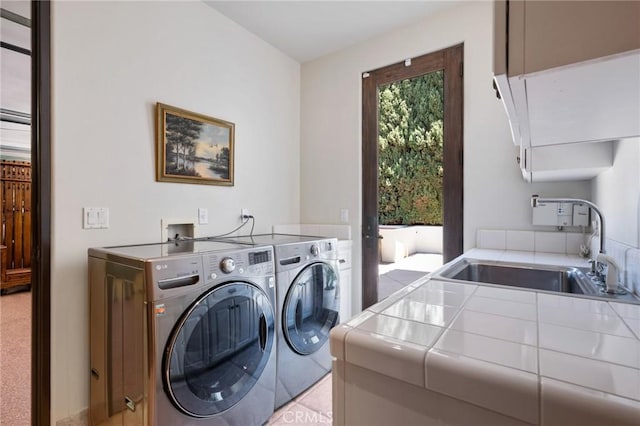 laundry room with independent washer and dryer and a sink