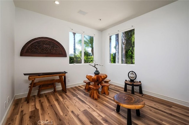 living area with visible vents, baseboards, recessed lighting, and wood finished floors