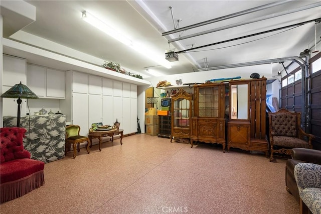 interior space featuring a garage and light speckled floor