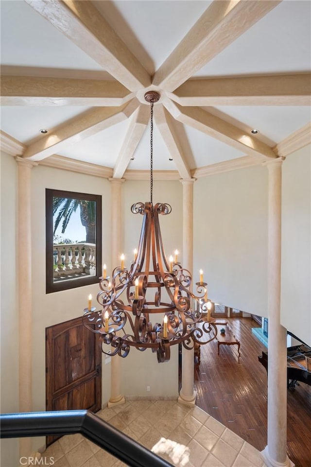 interior details with decorative columns, a notable chandelier, ornamental molding, and beam ceiling