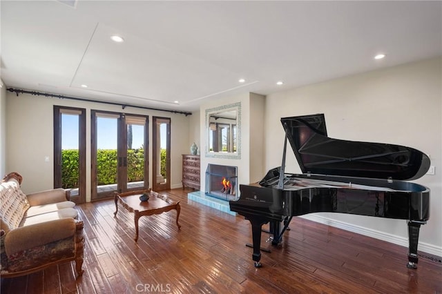 sitting room featuring hardwood / wood-style flooring, french doors, and baseboards