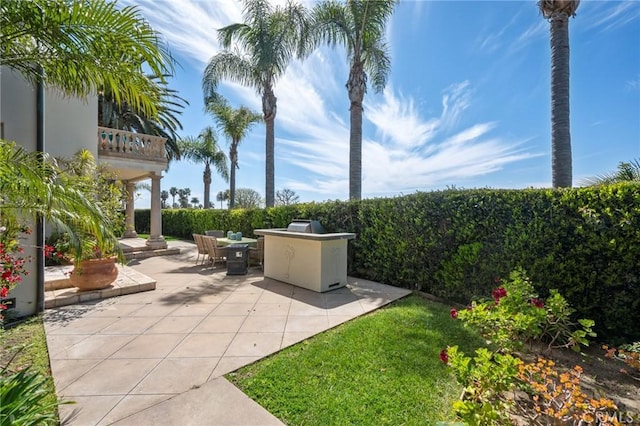 view of yard with outdoor dining space, a patio, a balcony, and area for grilling