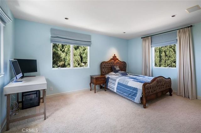 bedroom featuring carpet floors, baseboards, multiple windows, and visible vents