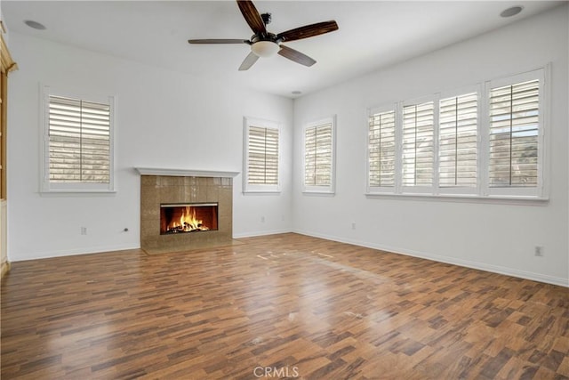 28514 High Ridge Dr, Saugus, CA 91390 - unfurnished living room featuring a tiled fireplace, ceiling fan, baseboards, and wood finished floors