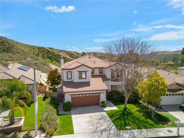 28514 High Ridge Dr, Saugus, CA 91390 - view of front of house featuring a front yard, a mountain view, a tiled roof, concrete driveway, and stucco siding