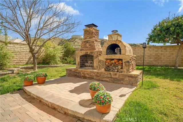 28514 High Ridge Dr, Saugus, CA 91390 - view of patio featuring fence and an outdoor stone fireplace