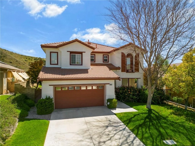 28514 High Ridge Dr, Saugus, CA 91390 - mediterranean / spanish home featuring a front yard, a tiled roof, concrete driveway, fence, and stucco siding