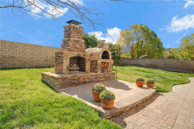 28514 High Ridge Dr, Saugus, CA 91390 - view of yard with a patio, a fenced backyard, and an outdoor stone fireplace