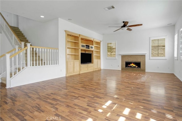 28514 High Ridge Dr, Saugus, CA 91390 - unfurnished living room featuring visible vents, a ceiling fan, wood finished floors, and a healthy amount of sunlight