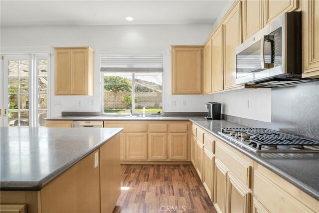 28514 High Ridge Dr, Saugus, CA 91390 - kitchen with dark countertops, wood finished floors, light brown cabinetry, and stainless steel appliances