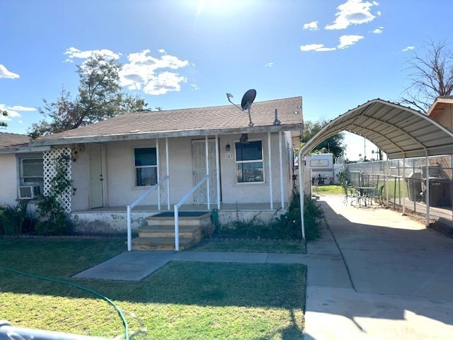 343 S Spring St, Blythe, CA 92225 - view of front of property with covered porch, stucco siding, a carport, a front lawn, and concrete driveway