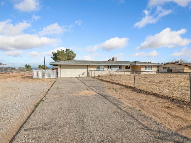 14435 Hopi Rd, Apple Valley, CA 92307 - ranch-style house featuring aphalt driveway, fence, and a garage