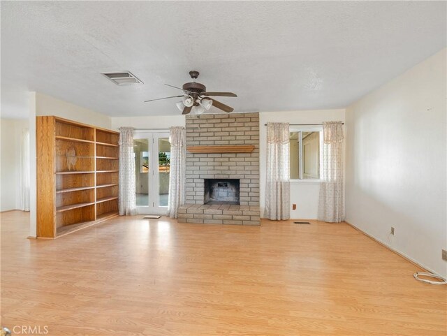 14435 Hopi Rd, Apple Valley, CA 92307 - unfurnished living room with ceiling fan, a textured ceiling, visible vents, and wood finished floors