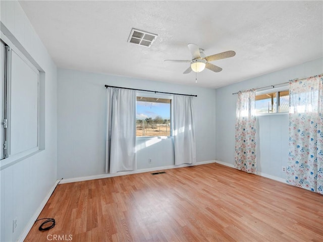 14435 Hopi Rd, Apple Valley, CA 92307 - empty room with baseboards, a ceiling fan, visible vents, and wood finished floors