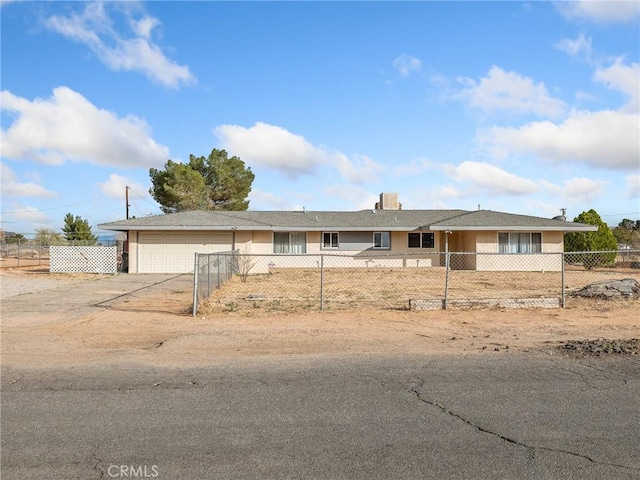 14435 Hopi Rd, Apple Valley, CA 92307 - view of front of house with a fenced front yard, concrete driveway, an attached garage, and stucco siding