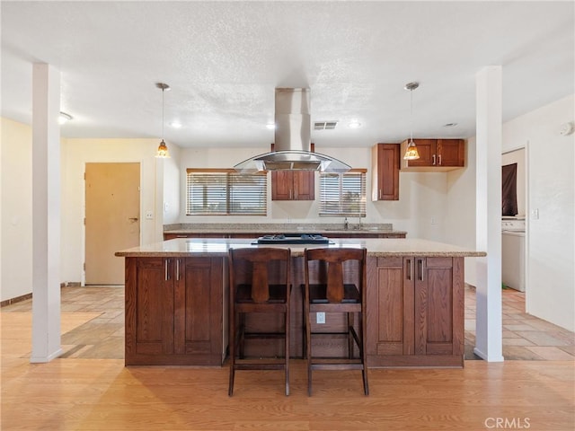 14435 Hopi Rd, Apple Valley, CA 92307 - kitchen with light wood-style flooring, a center island, pendant lighting, and island range hood