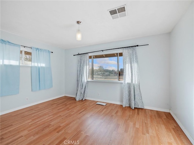 14435 Hopi Rd, Apple Valley, CA 92307 - unfurnished room featuring light wood finished floors, plenty of natural light, baseboards, and visible vents