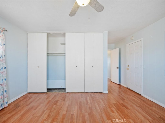 14435 Hopi Rd, Apple Valley, CA 92307 - unfurnished bedroom with a closet, a ceiling fan, wood finished floors, and baseboards