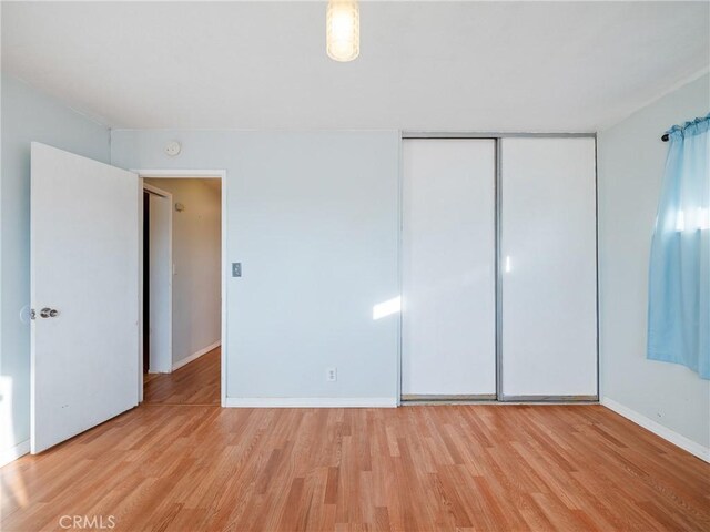 14435 Hopi Rd, Apple Valley, CA 92307 - unfurnished bedroom featuring baseboards, light wood-style floors, and a closet