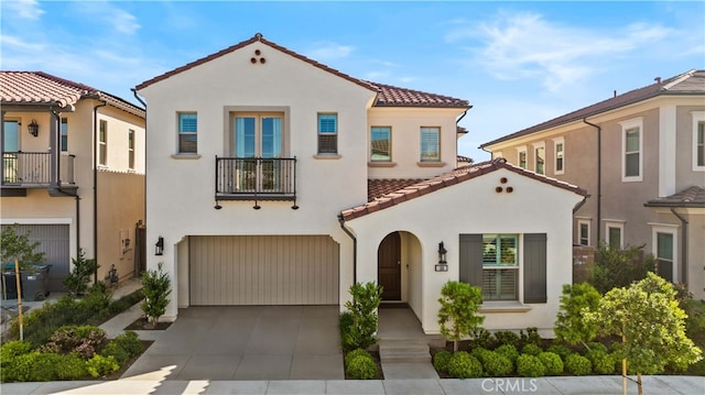 108 Hyperion, Irvine, CA 92618 - mediterranean / spanish house with a tile roof, driveway, an attached garage, a balcony, and stucco siding