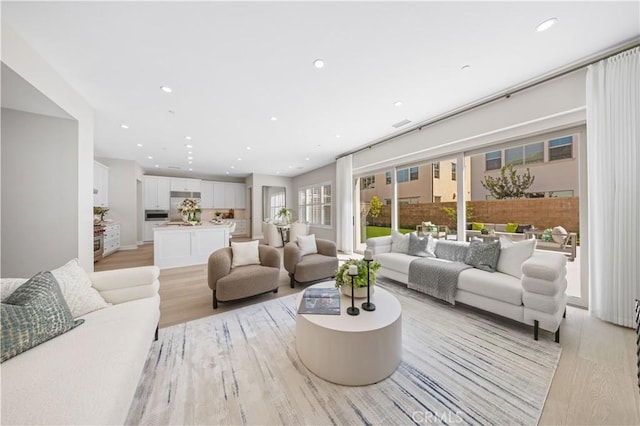 108 Hyperion, Irvine, CA 92618 - living room with recessed lighting and light wood-style flooring
