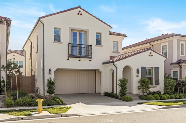 108 Hyperion, Irvine, CA 92618 - mediterranean / spanish-style home with a tile roof, driveway, a garage, a balcony, and stucco siding