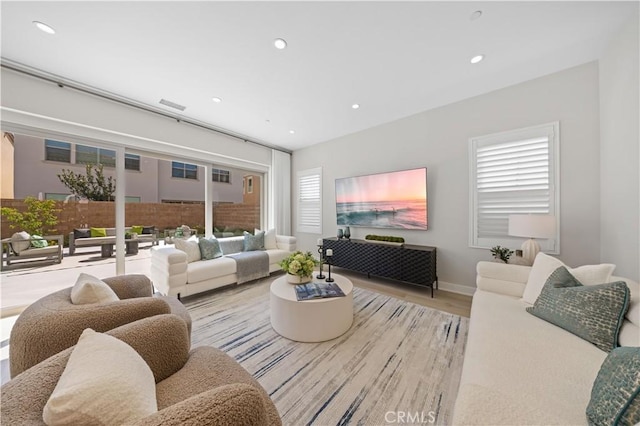 108 Hyperion, Irvine, CA 92618 - living room featuring recessed lighting, plenty of natural light, and wood finished floors