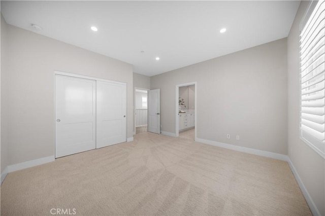 108 Hyperion, Irvine, CA 92618 - unfurnished bedroom featuring baseboards, recessed lighting, light colored carpet, a closet, and ensuite bath