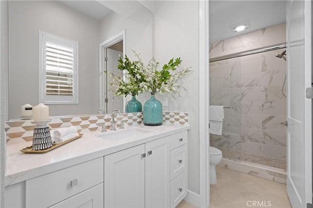 108 Hyperion, Irvine, CA 92618 - full bathroom featuring a shower stall, toilet, vanity, and decorative backsplash