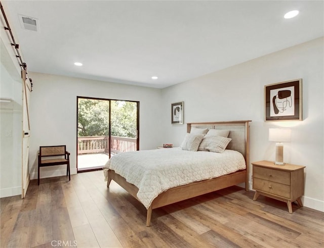 bedroom featuring light wood-style flooring, visible vents, access to exterior, and recessed lighting
