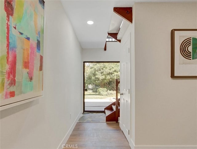 hallway with baseboards, recessed lighting, and wood finished floors