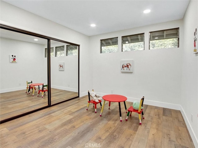 playroom with wood finished floors, baseboards, and recessed lighting