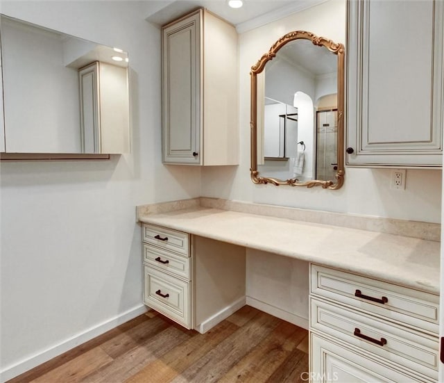 bathroom with wood finished floors, vanity, baseboards, and recessed lighting