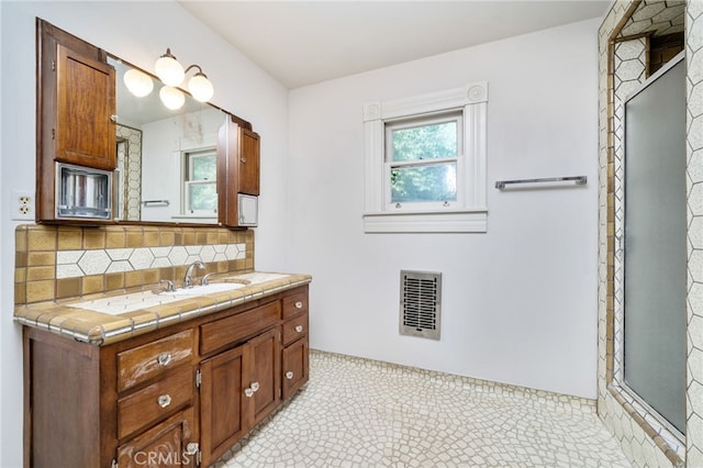 bathroom featuring a shower with shower door, visible vents, backsplash, and vanity