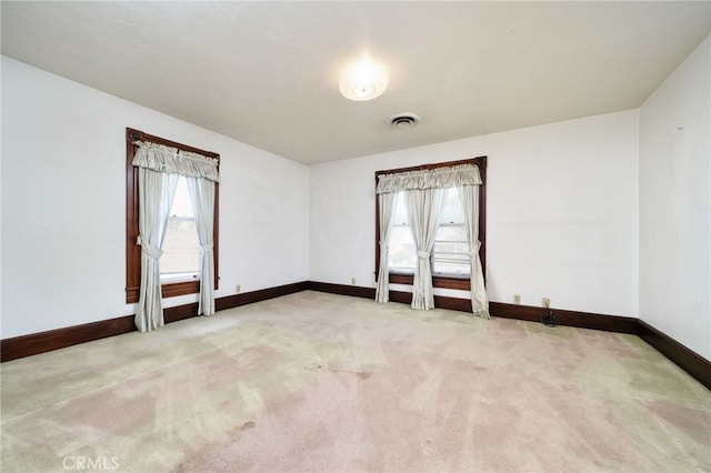 unfurnished room featuring carpet flooring, visible vents, and baseboards