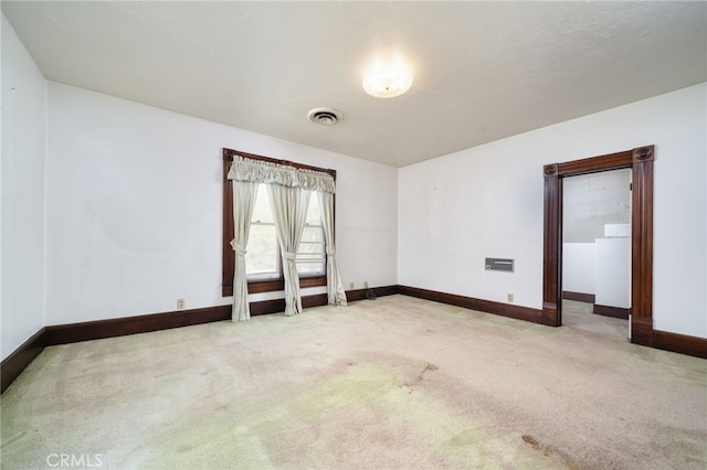 unfurnished room with baseboards, visible vents, and carpet floors