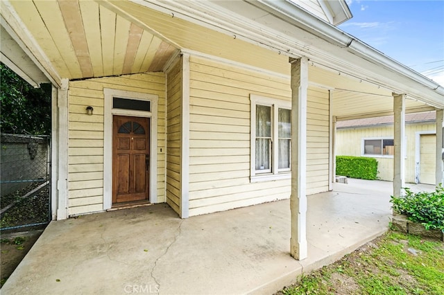 view of exterior entry featuring a porch