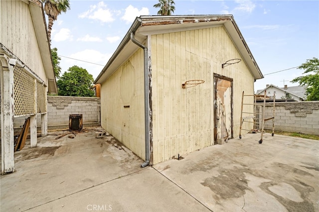 view of outbuilding featuring fence