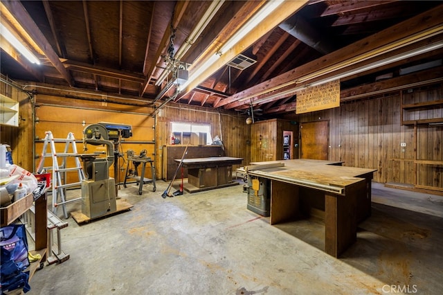 below grade area featuring wooden walls and a garage