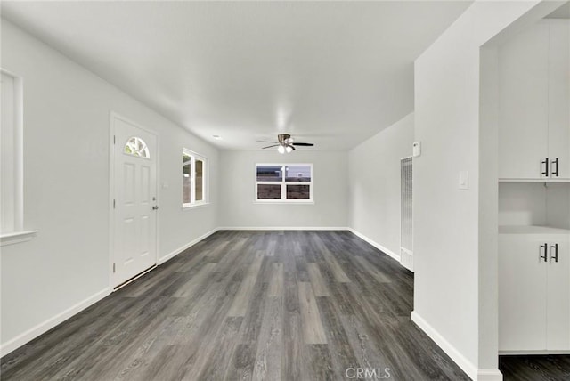 217 N Sacramento, Willows, CA 95988 - unfurnished living room featuring ceiling fan, dark wood-type flooring, baseboards, and a heating unit