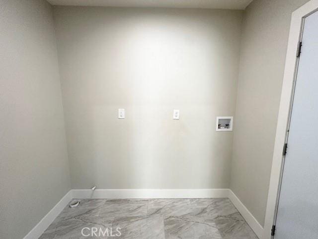 clothes washing area with baseboards, marble finish floor, laundry area, and hookup for a washing machine
