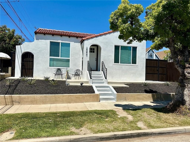 2209 W Glendon Way, Alhambra, CA 91803 - mediterranean / spanish home featuring stucco siding, a tiled roof, and fence